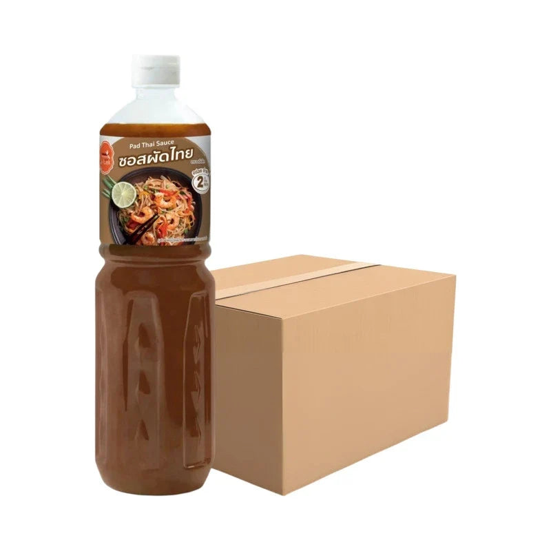 J-LEK Pad Thai Sauce bottles, 590g, in clear plastic bottles with red caps, suitable for Thai cooking and stir-fry dishes.