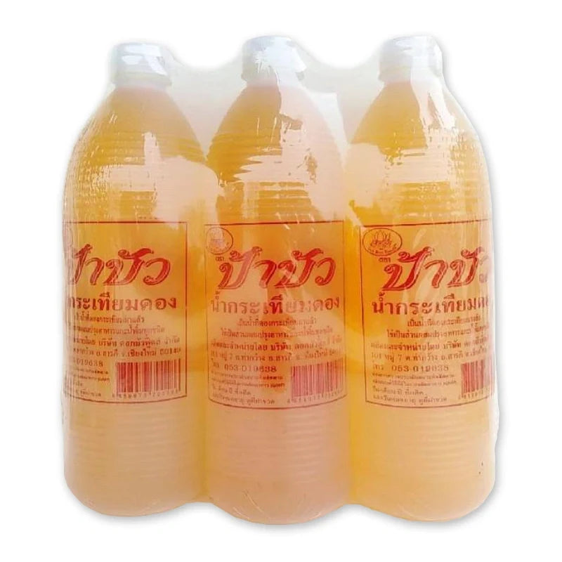 PA BUA Pickled Garlic Juice case with three 950ml bottles, shown in clear glass bottles with garlic and juice inside.