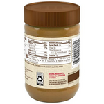 Creamy Jif Natural Peanut Butter jar showing the label and smooth texture in a grocery setting.