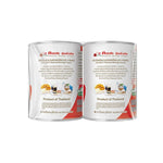 Carnation Sweetened Condensed Milk 505g cans stacked, showing labels and metal lids, in a dry grocery setting.