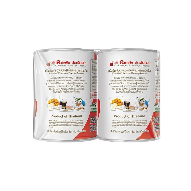 Carnation Sweetened Condensed Milk 505g cans stacked, showing labels and metal lids, in a dry grocery setting.