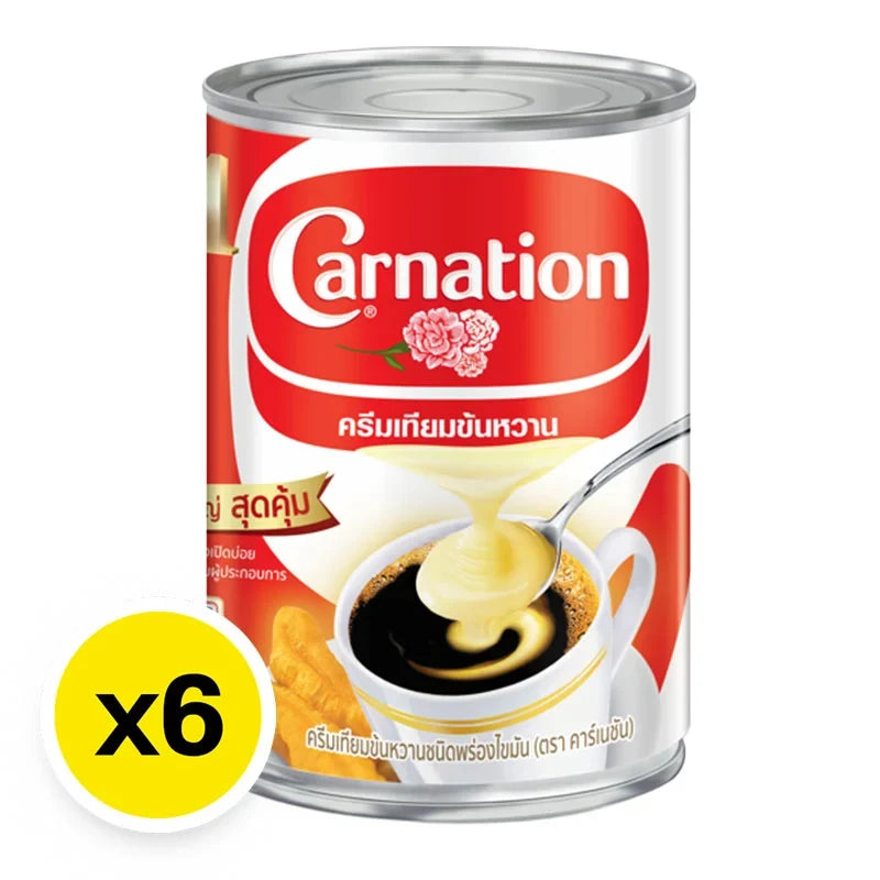 CARNATION sweetened condensed milk in 505g cans, six-pack, ideal for baking and desserts, stored in a dry grocery setting.