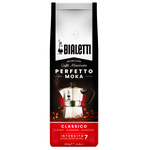 Bialetti Classico coffee drink in a glass with ice, garnished with a lemon slice, served in a clear glass on a wooden table.