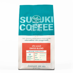 Suzuki Swiss Blend drink in a clear glass with a dark amber color, showcasing a refreshing beverage.