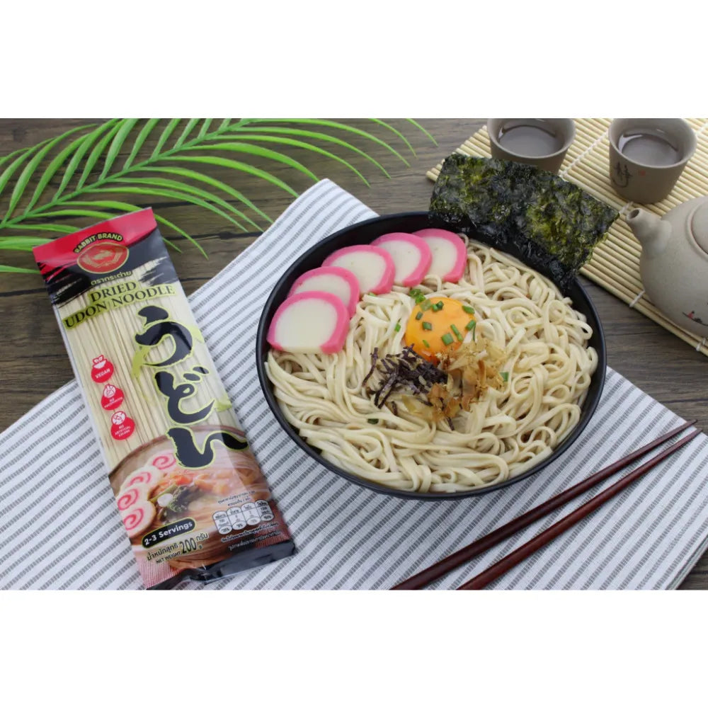 Dried Rabbit Brand Udon Noodles in a clear package, showcasing thick, white Japanese-style wheat noodles for cooking.