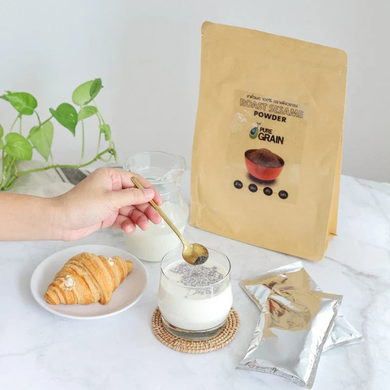 Pure Grain 100% ground roasted black sesame in a 500g package, ideal for cooking and baking in dry grocery recipes.