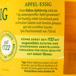 Kuhne Apple Cider Vinegar in a clear glass bottle, showcasing its golden liquid and label with brand and product details.