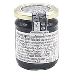 Giuliano Tartufi Black Truffle Sauce in 180g jar, showcasing dark truffle flecks and rich sauce texture in a glass container.