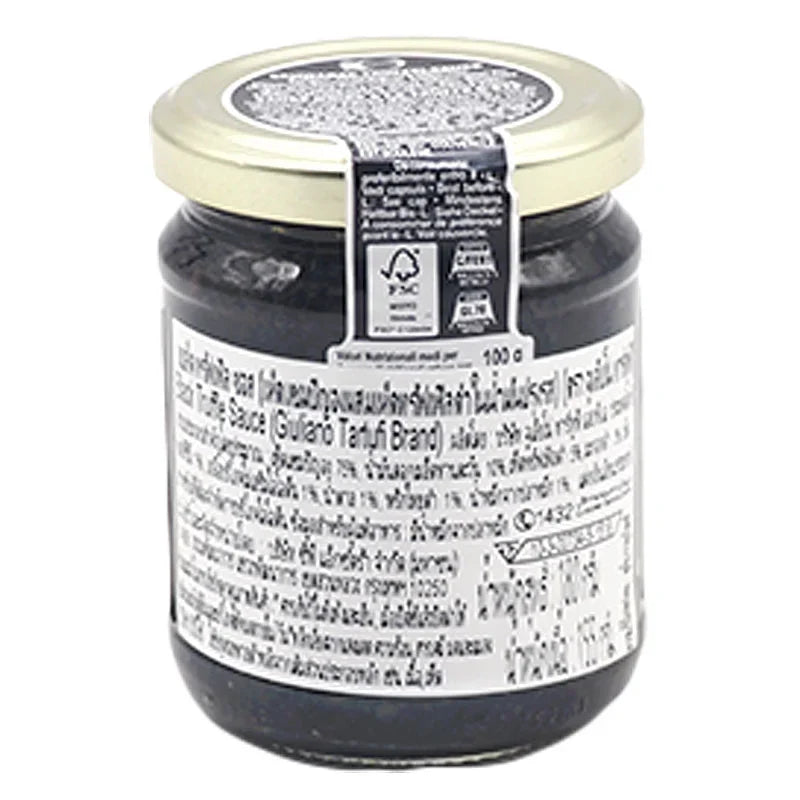 Giuliano Tartufi Black Truffle Sauce in 180g jar, showcasing dark truffle flecks and rich sauce texture in a glass container.