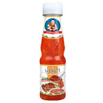 Deksomboon Sweet Chili Sauce 180g bottle from dry grocery aisle, with bright label and red chili sauce visible.