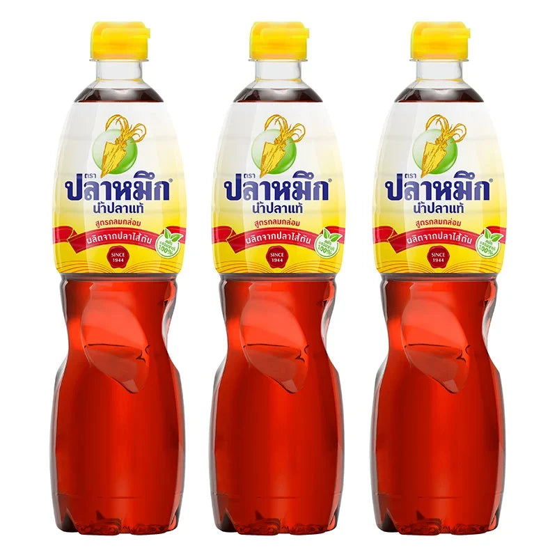 Three 700ml bottles of Squid Brand Fish Sauce in yellow bottles, used for cooking and seasoning in Asian cuisine.