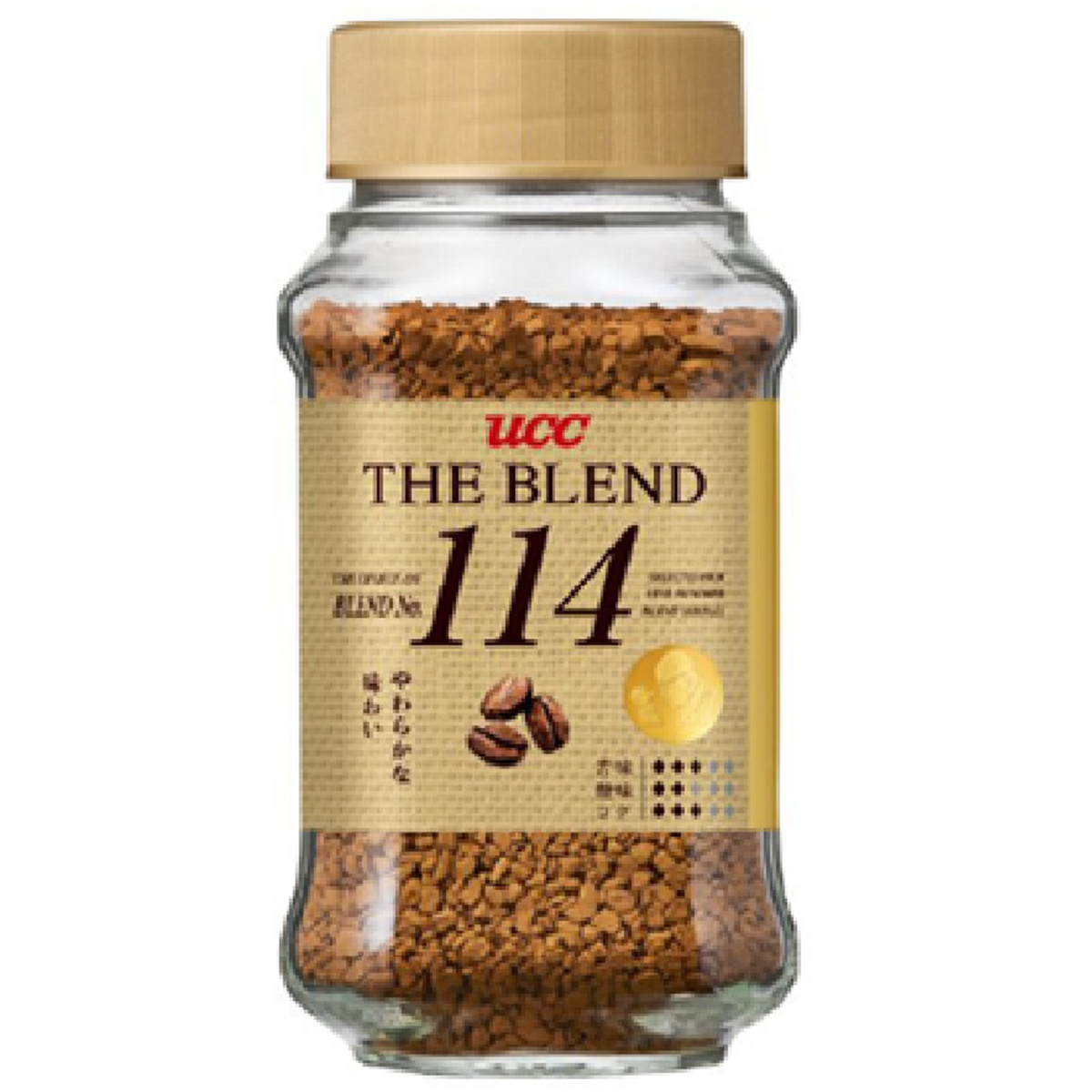 Ucc The Blend No.114 instant coffee drink in a glass mug with a spoon, showcasing rich coffee and creamy foam on top.