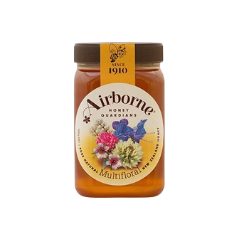 Jar of Airborne Multifloral Honey with a golden color and floral label, showcasing fresh honey in a glass container.