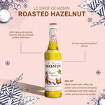 Bottle of MONIN Hazelnut Syrup in 700ml size, ideal for coffee and dessert flavoring, with a clear label and dark brown liquid inside.