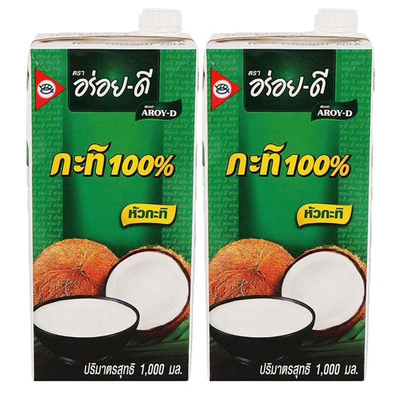 Aroy-D Coconut Milk Prisma 1L bottles, dry grocery, creamy coconut milk in clear bottles with white caps, two-pack for cooking and baking.