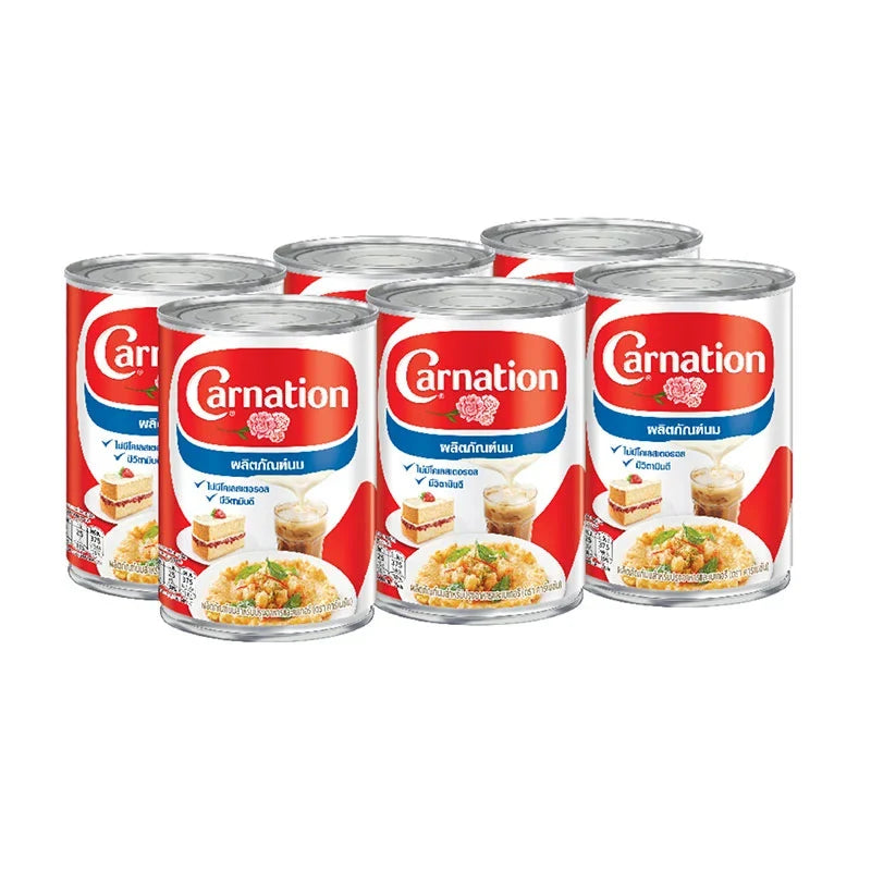 Carnation evaporated milk 405g cans stacked, ideal for baking and cooking, in a dry grocery product display
