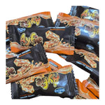 Nezline Toffee Caramel Nut Crisp snack in a clear wrapper, showing golden toffee, caramel, and crunchy nut pieces.
