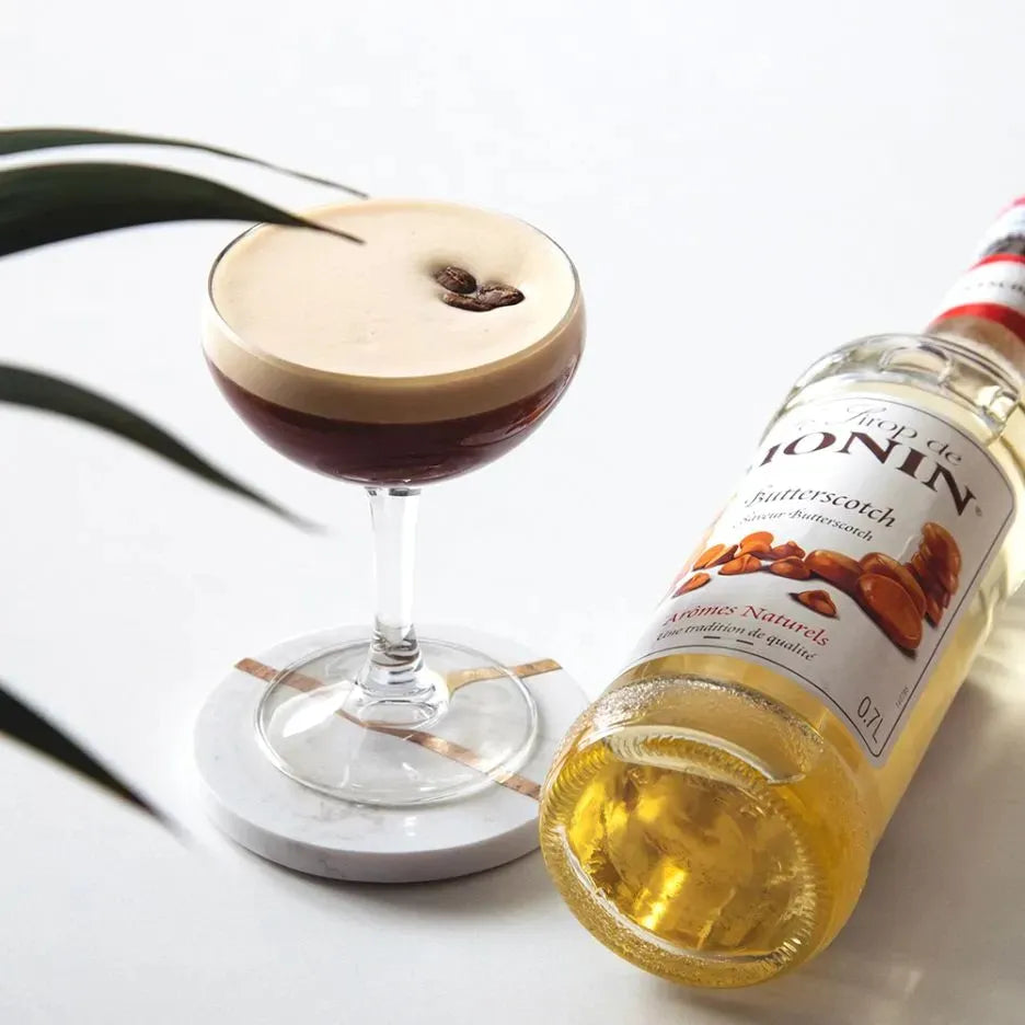 Monin Butterscotch Syrup 700ml bottle, ideal for coffee and desserts, with a rich butterscotch flavor in a clear plastic bottle