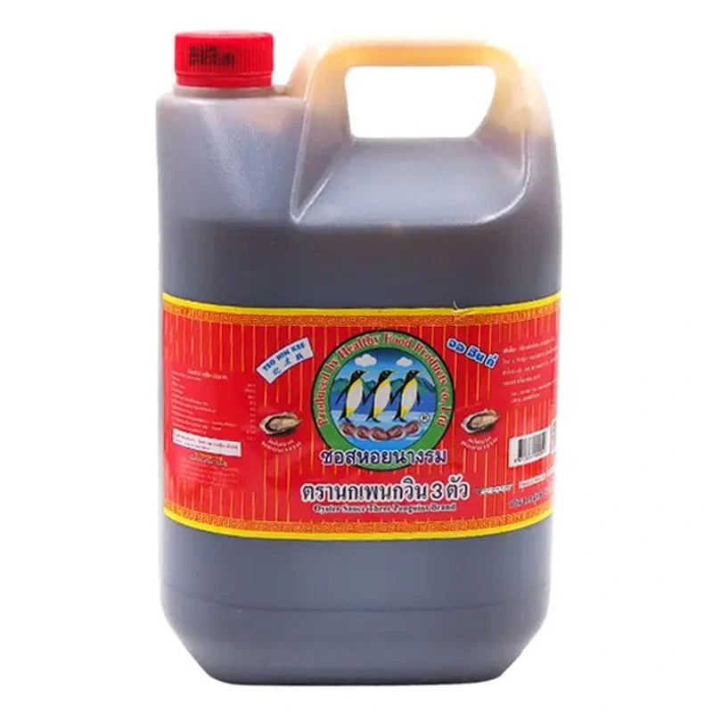 Three Penguins Oyster Sauce 5kg jar shown, traditional Asian cooking ingredient in a large plastic container for dry grocery use.