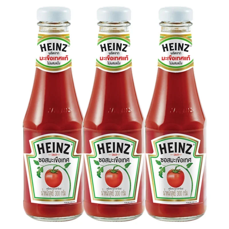 Heinz Tomato Sauce 300g bottles, three-pack, in a dry grocery product image showing the iconic Heinz label and red sauce bottles.