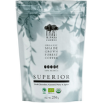 Mivana Organic Coffee Superior drink in a clear glass with coffee beans and a spoon, showcasing the refreshing beverage.