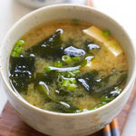 Shinsyuichi Instant Miso Soup with Wakame seaweed in 156g dry grocery package, prepared and served in a bowl.