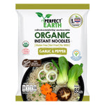 Perfect Earth Organic Instant Noodles with garlic and pepper, featuring a bowl of prepared noodles on a grocery shelf.