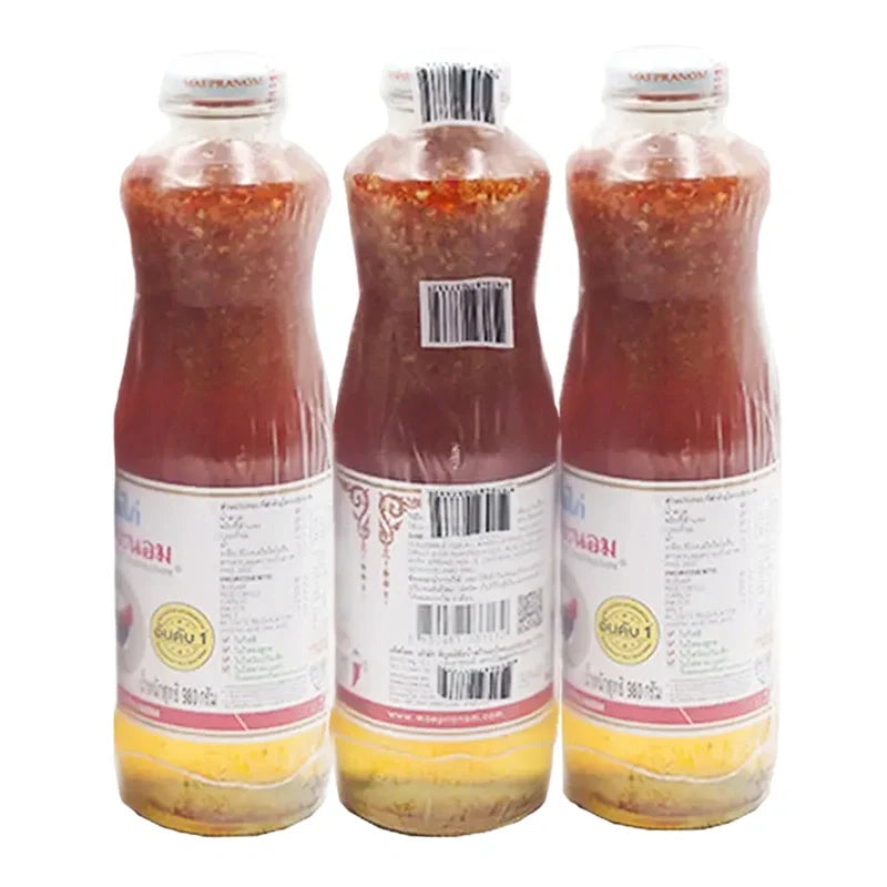 Maepranom Chicken Sauce in 980g bottles, featuring a dark, savory liquid with a label displaying the MAEPRANOM brand name.