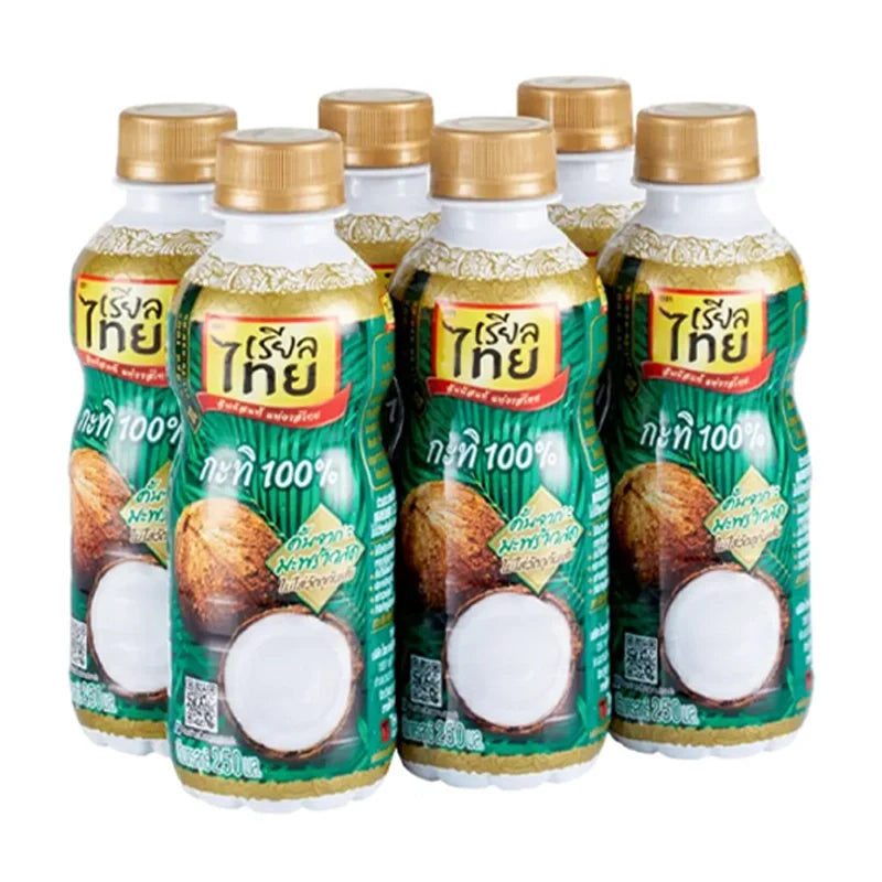 Six bottles of REAL THAI Coconut Milk in 250ml PET containers, displayed in a dry grocery setting.