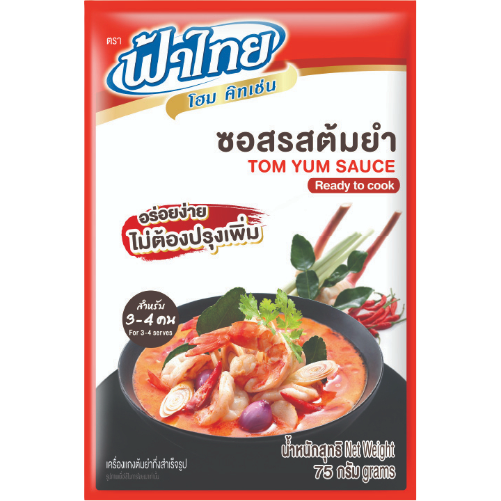 Bottle of Fa Thai Tom Yum Sauce, a Thai grocery item, with red chili, herbs, and garlic visible in the sauce label.