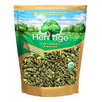 Heritage Organic Raw Pumpkin Seeds 454g in a clear bowl, showing light green and tan pumpkin seeds for healthy snacking or cooking.