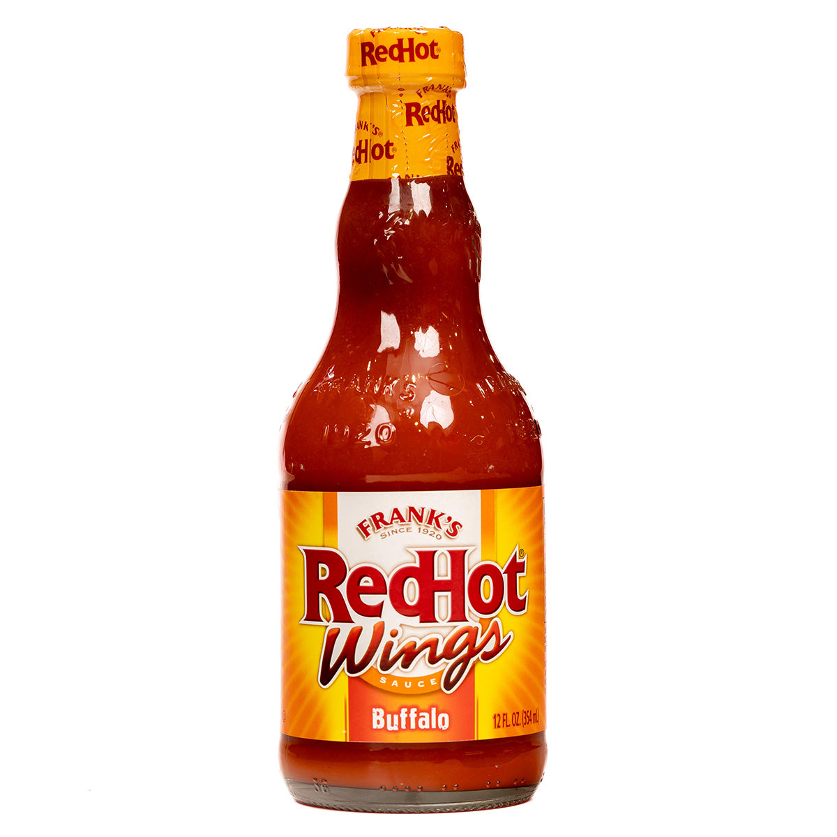 Bottle of Frank's Buffalo Wing Sauce showing the label and golden sauce inside, ideal for adding spicy flavor to dishes.
