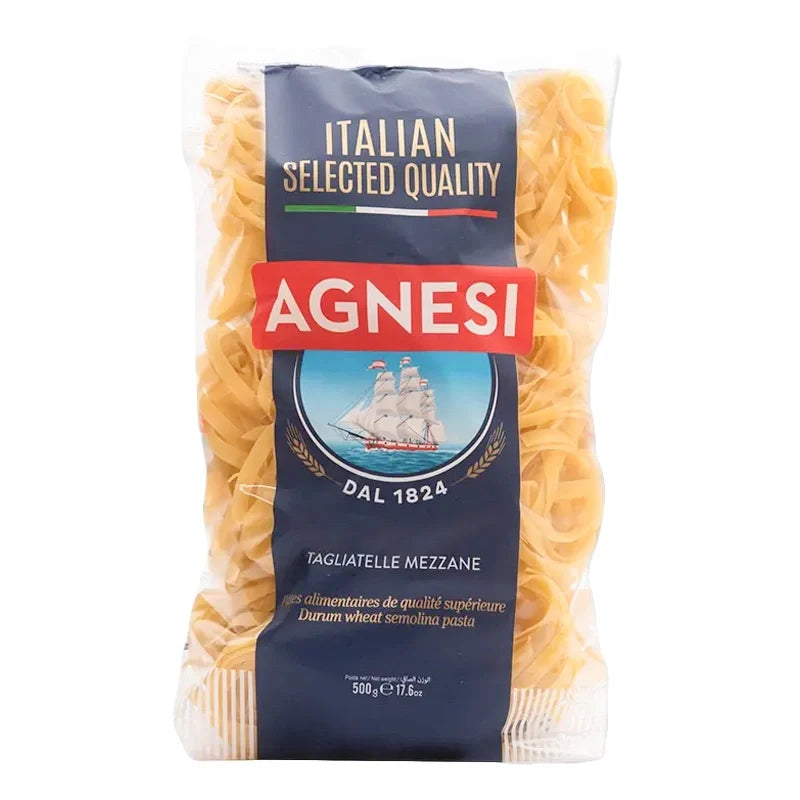 Dry Agnesi Tagliatelle Mezzane pasta in 500g package, showing golden, flat ribbon-shaped pasta strands on a white background.