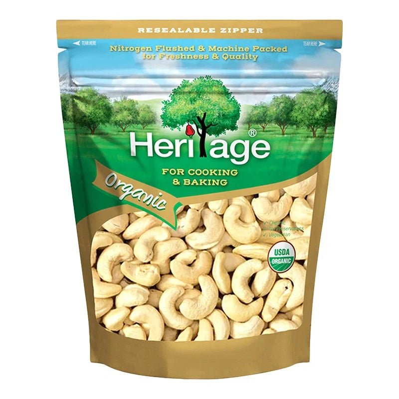 Heritage Organic Raw Broken Cashew Nuts in 250g bag, dry grocery product with visible broken cashew pieces and natural nut appearance.