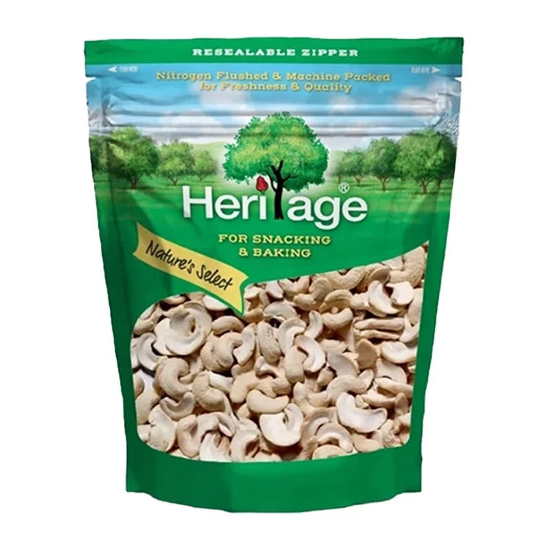 Heritage Toasted Split Cashew Nuts 500g in a clear plastic bag, showing golden-brown toasted cashews ready for snacking or cooking.