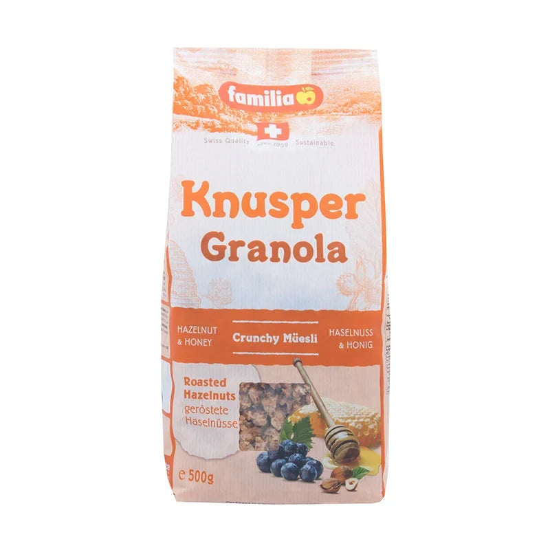 Familia Knusper Crunch Granola 500g in a clear plastic bag with golden clusters and oats, perfect for breakfast or snacking.