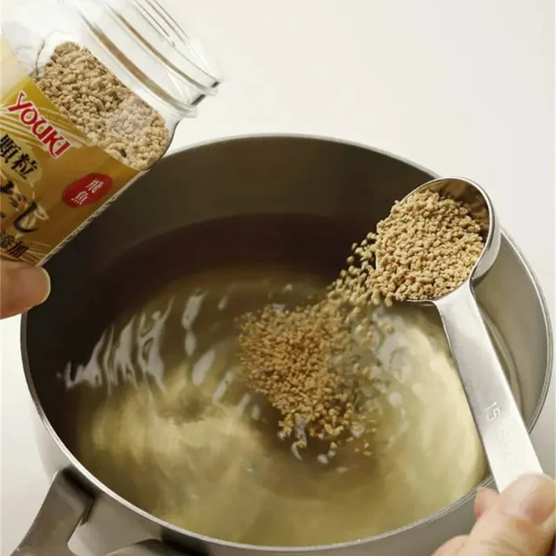 Youki Granule Fish Dashi Soup Stock with Roasted Chin Flying dried fish granules in a clear container, for Japanese cooking.