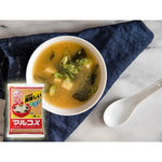 Marukome Ikkyu-San Dashi Miso White Koshi with Soybeans in a clear bowl, showing the white miso paste and soybean ingredients.