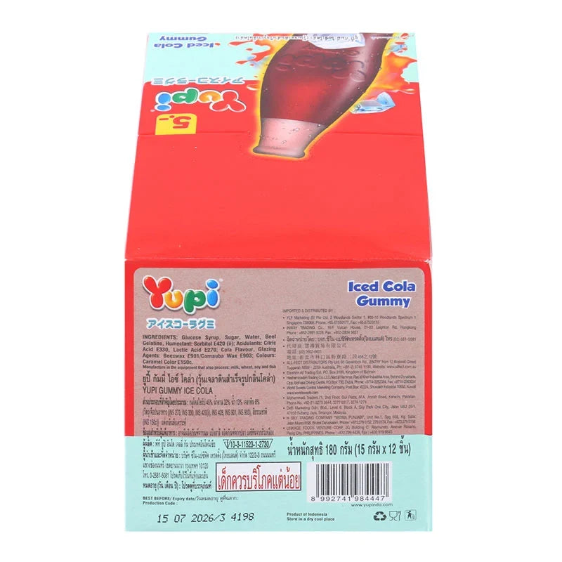 YUPI Yupi Gummy Ice Cola candies in 15g packs, colorful gummy snacks with cola flavor, arranged in a pile on a white background.