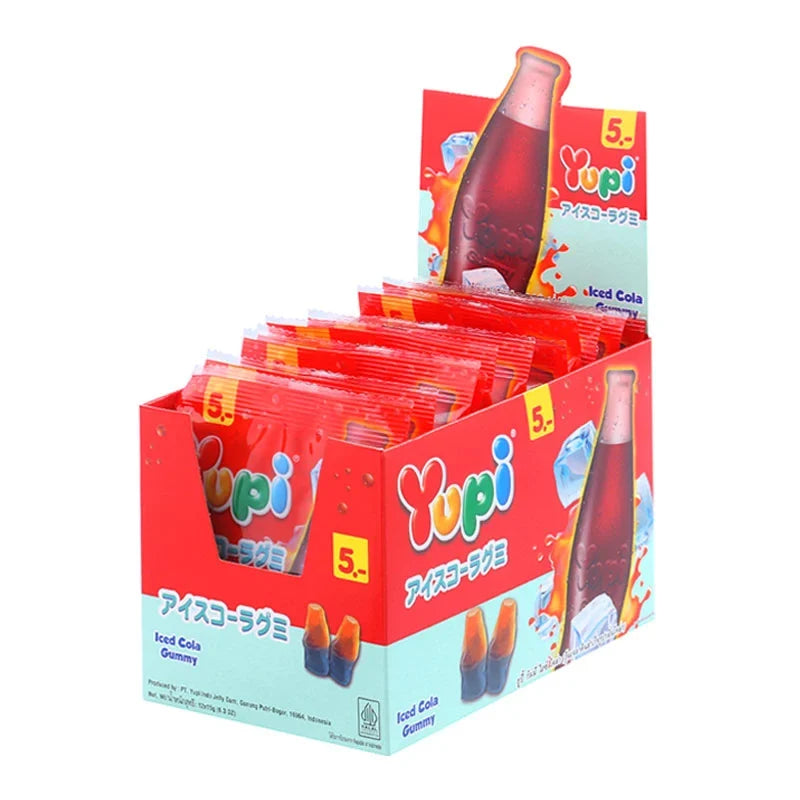 Yupi Gummy Ice Cola candies in 15g packs, colorful gummy snacks from YUPI, displayed in a clear bowl with packaging in the background.