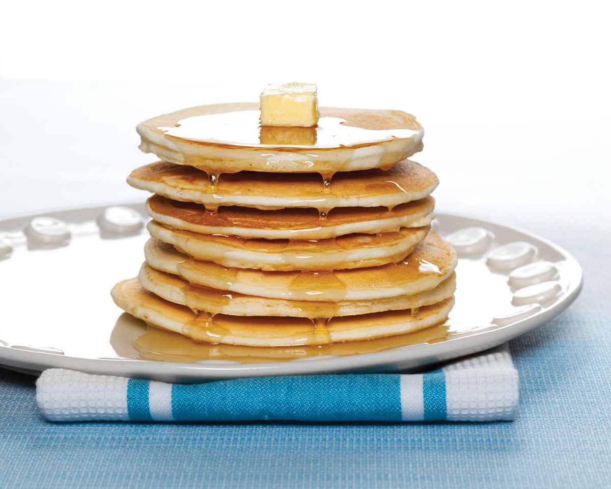 Yes You Can Butter Milk Pancake in a bowl, showing a healthy grocery product with a golden pancake topped with butter and syrup.