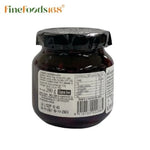 Jar of LA Vieja Fabrica Cherry Mermelada in glass jar, showcasing vibrant cherry jam with a rustic label.