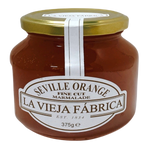 Jar of Fragata orange marmalade jam with a spoon, showcasing bright orange color and smooth texture in a grocery product image.