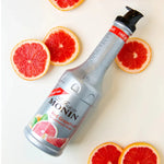 Bottle of Monin Red Grapefruit Fruit Mix 1000ml for dry grocery, featuring vibrant red grapefruit flavor and branding.