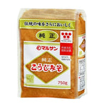 Marusan-ai Jyunsei Koji Miso made with soybeans, dry grocery product, in a jar with a label, close-up of the miso paste.