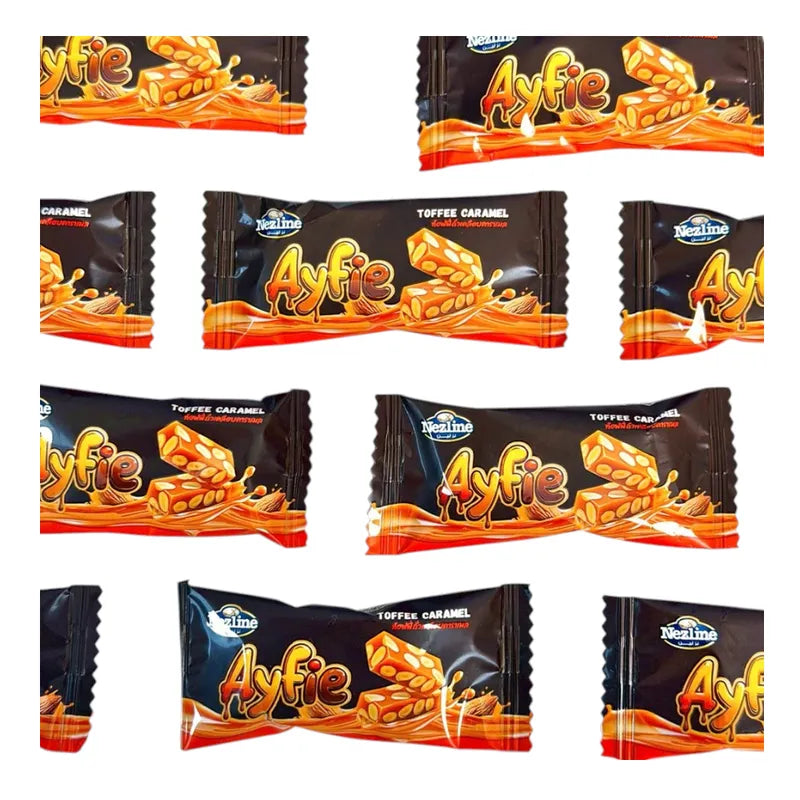 Nezline Toffee Caramel Nut Crisp snack in a clear wrapper, showing golden toffee, caramel, and crunchy nut pieces.