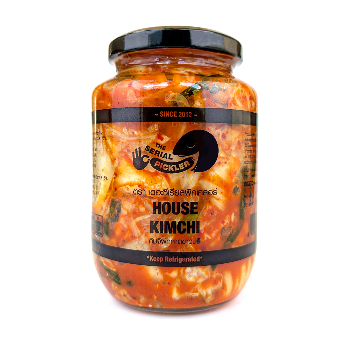 Jar of The Serial Pickler House Kimchi with fresh vegetables and spices in a glass container, showcasing traditional Korean fermented kimchi.