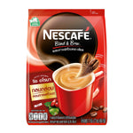 Nescafe Blend and Brew instant coffee mix in a jar, showcasing rich aroma and a scoop of coffee powder on a wooden surface.
