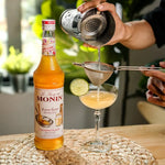 Bottle of MONIN Brown Butter Flavored Syrup 700ml for adding rich, buttery flavor to beverages and desserts.