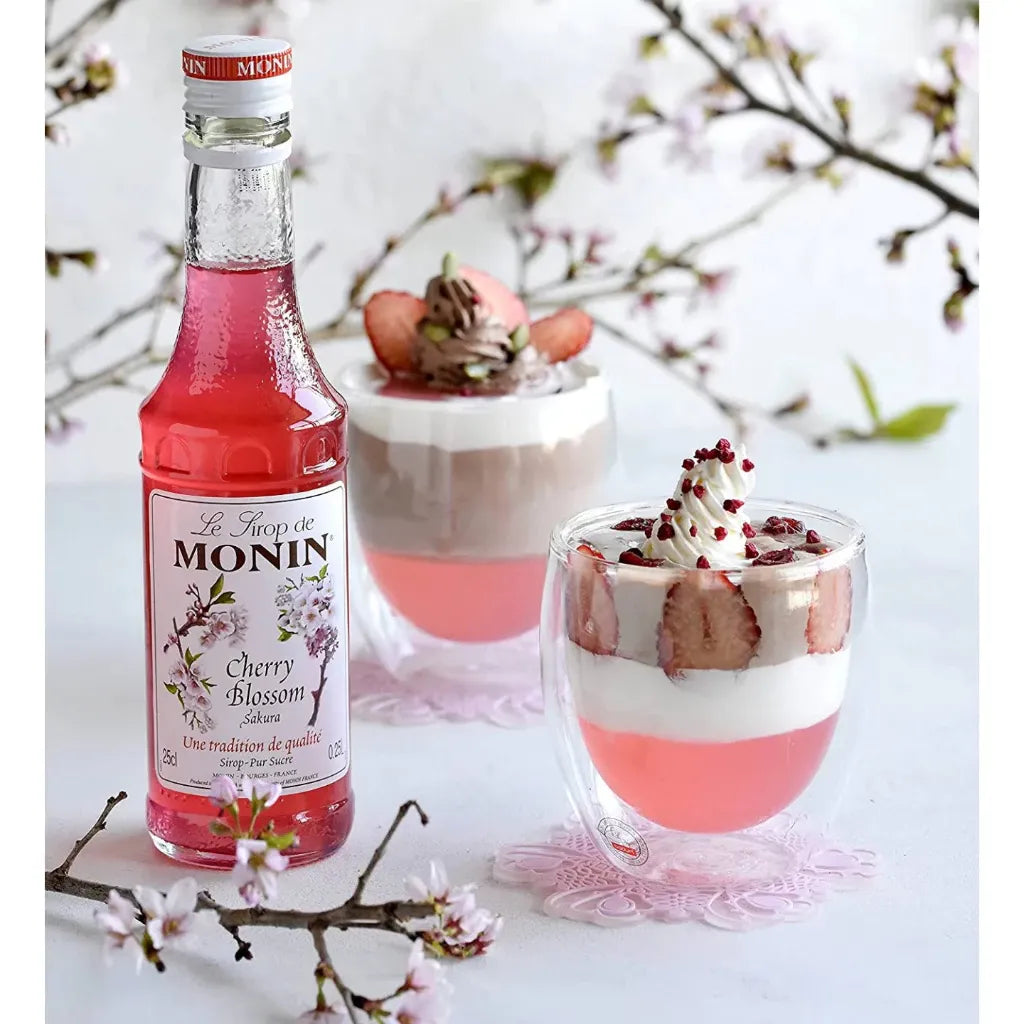 Bottle of MONIN Cherry Blossom Syrup in 700ml size, perfect for cocktails and desserts, with a cherry blossom floral label.